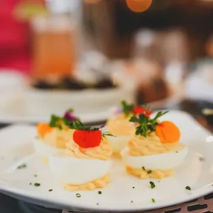 a plate of deviled eggs with garnish