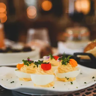 a plate of deviled eggs on a table