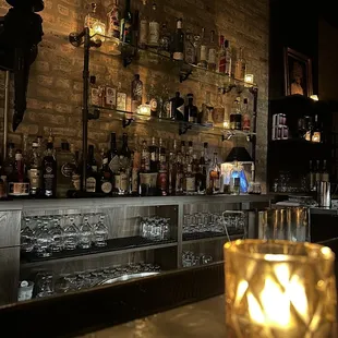 a lit candle on the bar counter