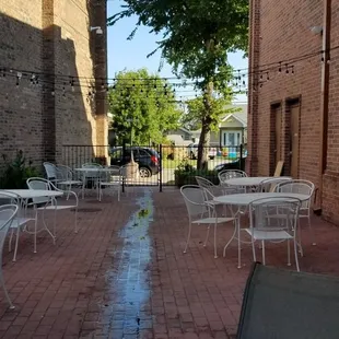 tables and chairs on a brick patio