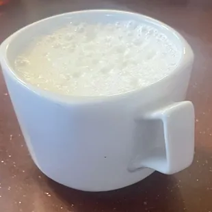 a cup of milk on a table