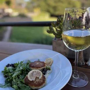 a plate of food and a glass of wine