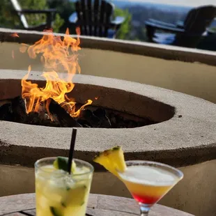 a fire pit and two cocktails