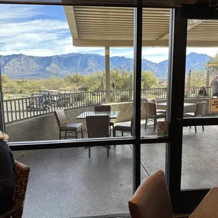 View of patio and mountains from inside restaurant