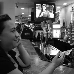 a woman handing a bottle of wine to a man