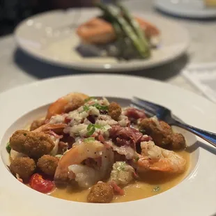 Shrimp and Grits (foreground) and Salmon with mushroom risotto (background)