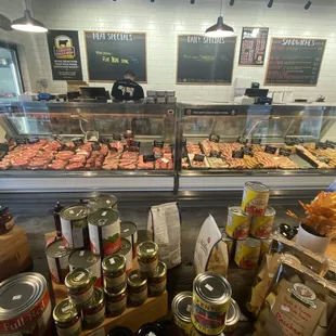 Butcher case with fresh meats and great high end pantry items