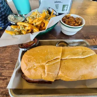 Tri tip sandwich with side of beans and garlic fries