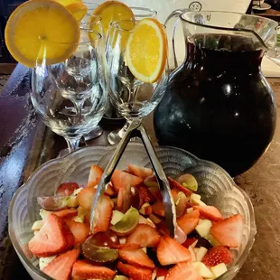a bowl of strawberries and orange slices