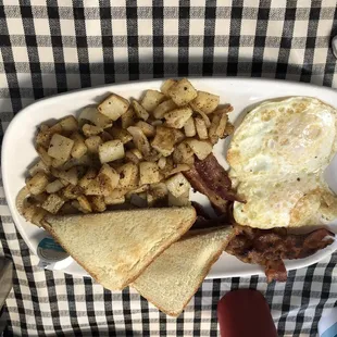 Two eggs, bacon, toast, homestyle potatoes