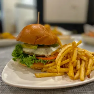 Turkey Burger topped with Mozzarella Lettuce Tomato Avocado and Cucumber