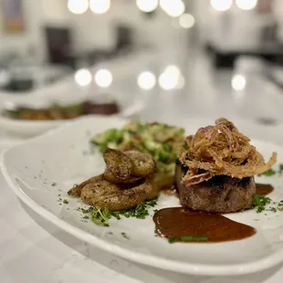 Marinated Sirloin served with Brussels sprouts Hash, Roasted Fingerlings topped with fried onion straws and VG Steak Sauce