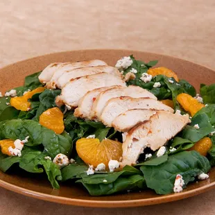 a plate of spinach and oranges