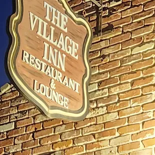 a sign on the side of a brick building