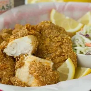 a basket of fried chicken and coleslaw