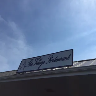 a sign for the village restaurant