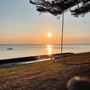 the sun setting over the water