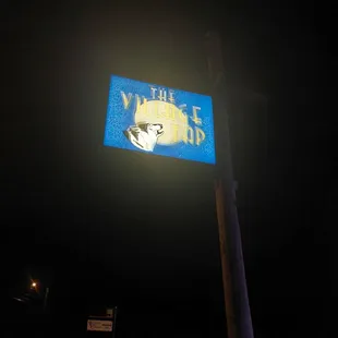 a street sign lit up at night