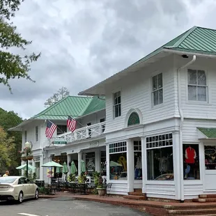 a white building with a green roof