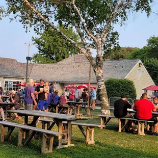 people sitting at picnic tables