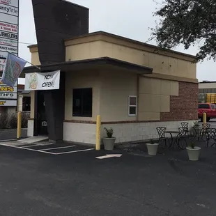 Small building in the parking lot of Whiskey River and Tokyo Grill.