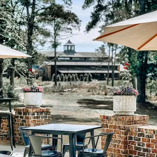 tables and chairs with umbrellas