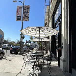 Some outdoor seating on the sidewalk