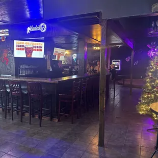 a bar with a christmas tree in the background