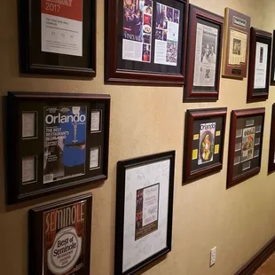 a wall full of framed wines