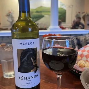 a bottle of wine and a glass of wine