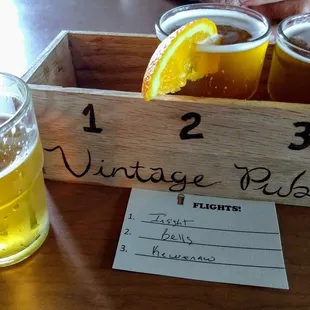 a flight of beer in a wooden crate