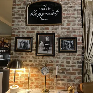 a brick wall with a sign above it