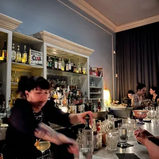 a group of people sitting at a bar