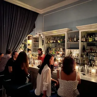 a group of people sitting at a bar