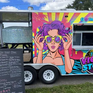 a woman with purple hair and sunglasses