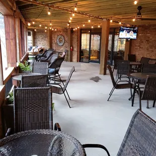 a patio with tables and chairs