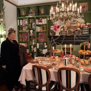a woman standing in front of a dining room table