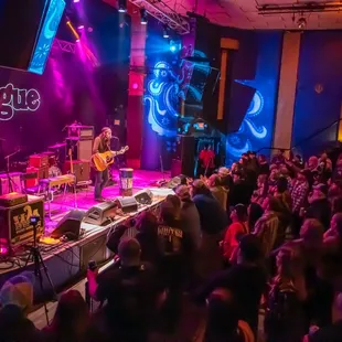 a band performing on stage in front of a crowd