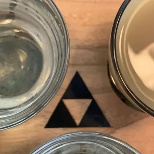 three glasses of water on a wooden table
