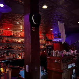 a dimly lit bar with purple lighting