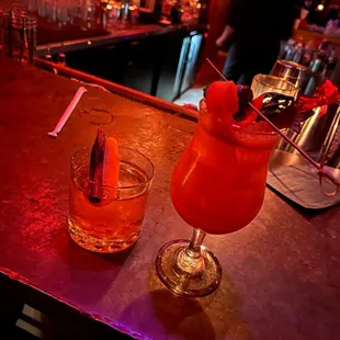 two cocktails on a bar