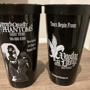 two black cups with white graphics