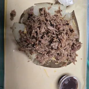 Brisket baked potato with butter, Cheddar and tons of brisket, and optional sour cream and BBQ sauce.  So tasty!