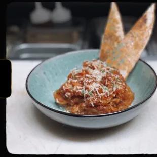 a bowl of pasta and bread
