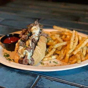 a steak sandwich and fries
