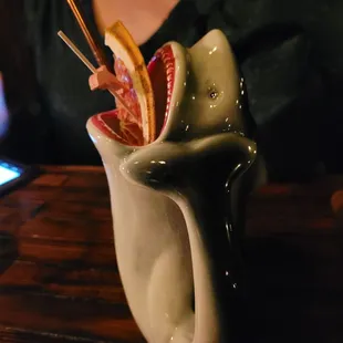 a woman holding chopsticks in a cup