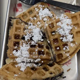 Blueberry waffle with powdered sugar and cream