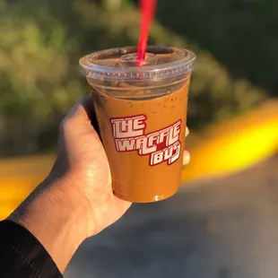 a hand holding a cup of coffee