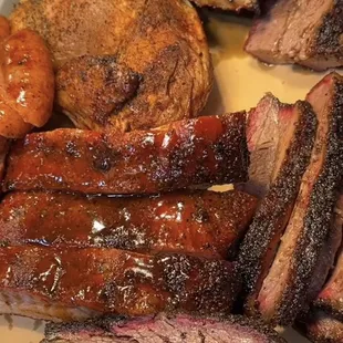 a platter of meat and vegetables
