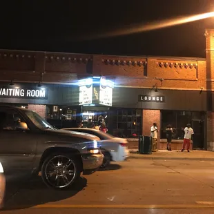 a group of people waiting outside of a restaurant